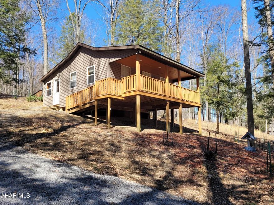 Cute getaway in a wooded setting.  One bedroom, one bath cabin with an enclosed back porch for added living space.  Full front porch for relaxing while watching the wildlife.  Perfect for a full time residence or second home.  Electric baseboard heat.  Close to the dog park.