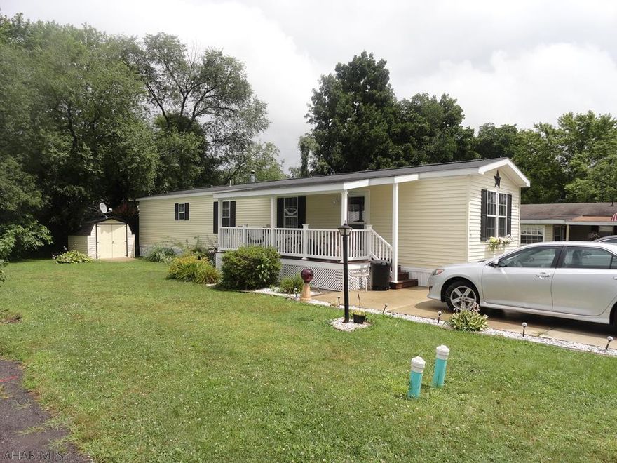 Beautiful & spacious 14 x 70 mobile home  with tile countertops, all appliances, cathedral ceilings, covered porch for summer entertaining, shed, cement driveway.