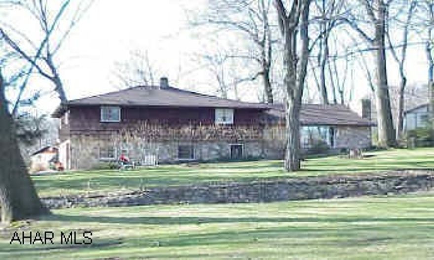 Nice Stone & cedar split level on Frankstown Rd. Beautiful lot w/ stream, 2 stone fireplaces in LR & family room. Call office for special Sales Agreement, copies of inspection reports and special addendums.