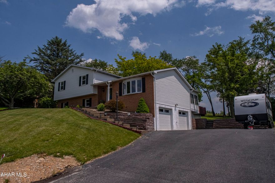 MOVE- in READY, with major upgrades and serene backyard views—all in the sought-after Hollidaysburg School District! This beautifully updated home features a new roof and hot water heater (2024), a full UV well water filtration system (2023), new carpets, fresh paint, stylish light fixtures, and brand-new garage doors. Step outside and take in the amazing open land view—a peaceful, private backdrop perfect for relaxing evenings or entertaining. The recently serviced hot tub with a new cover offers the perfect spot to unwind. Pet lovers will appreciate the invisible fence system, making it easy to let your dog roam safely. This home blends thoughtful upgrades with tranquil outdoor living.