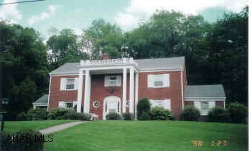 Brick Colonial Home, older prestige, nicely landscaped. Elegant home with 4 bathrooms, hardwood floors under all the carpets, all appliances included, crown molding. Full basement with knotty pine walls, family room with wet bar and fireplace.