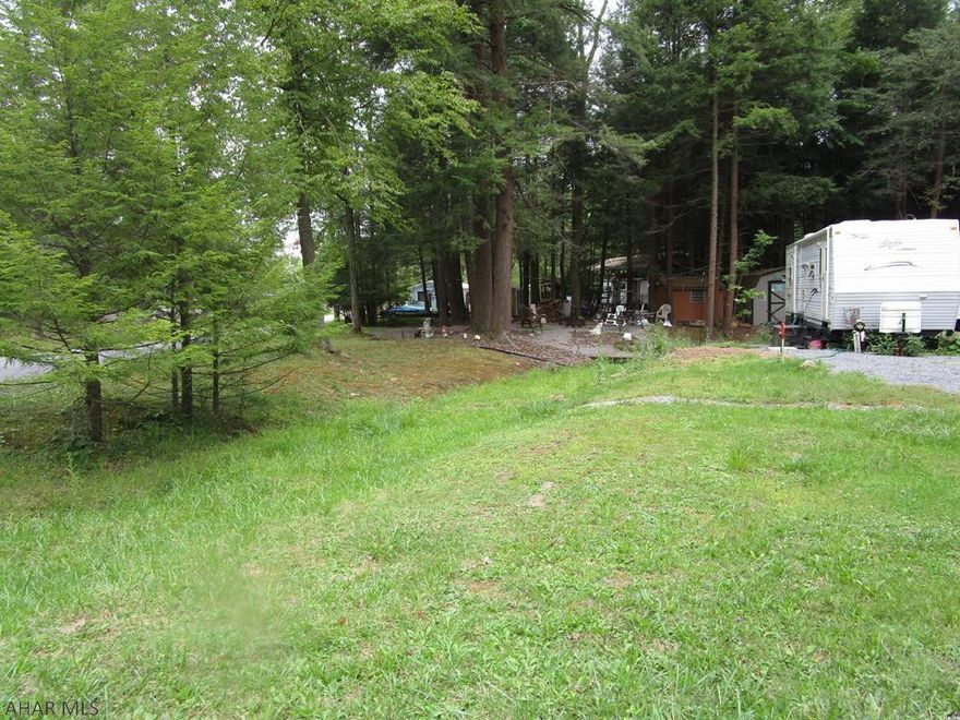 Large campsite ready for your camper.  Established fire pit area and shed.  Come and get it away from it all.