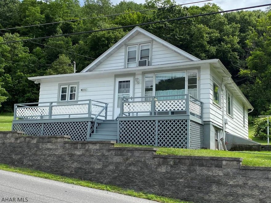 The perfect family home on a double lot with public water and sewer. Relaxing front deck to enjoy the summer evenings. This 4-bedroom home has plenty of closets. Thermopane windows, dining room with built-in shelves and includes a shed/storage building once used as an office. This could be the spot for your "alone time".