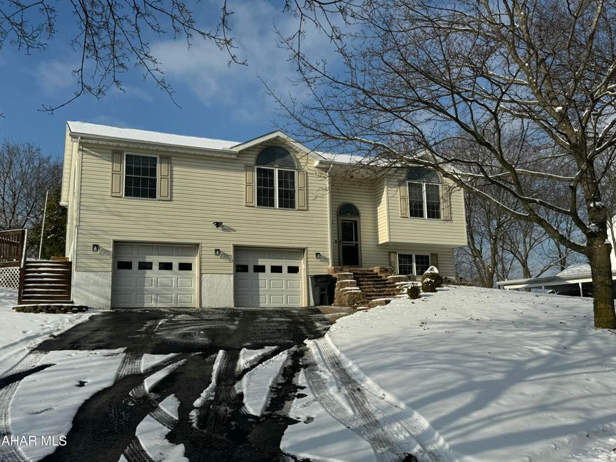 Nestled in the Juniata section of Altoona, this well-maintained split-level home, built in 2000, offers a perfect blend of modern comfort and functional living spaces. The open floor plan creates an inviting atmosphere, ideal for both daily living and entertaining. The primary bedroom features a large en suite bathroom with a walk-in closet and a cozy electric fireplace.  The lower level is designed with a family room that includes a gas fireplace and home office area, while the 3/4 bath on this level offers added convenience.  Outside, you'll find a large covered patio with a 30 amp RV plug access and grilling area, ideal for outdoor entertaining. The property also boasts a unique wood-fired brick oven.  This home combines comfort, style, and functionality in a great location.