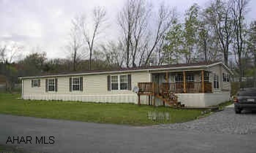Spacious and lovely 3 bed, 2 bath, 28x62 doublewide with oak kitchen, fireplace, large deck front to back, above ground pool and hot tub.