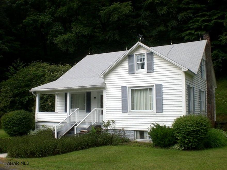 Well built cape home w/ 1,827 sqft w/ 4 BR, lg family rm, LR, kitchen w/ eat-in area & an updated full bathroom. Full bsmt w/ 1-car integral garage. Pine board floors, oak staircase, thermo pane windows, oil FA heat & front covered porch. Native trout stream (Bob's Creek) just across the road & Blue Knob State Park just up the road. This property is in good condition w/ exceptional owner care!