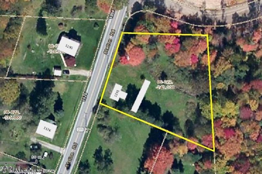 1.1 acre lot with city water & sewage.