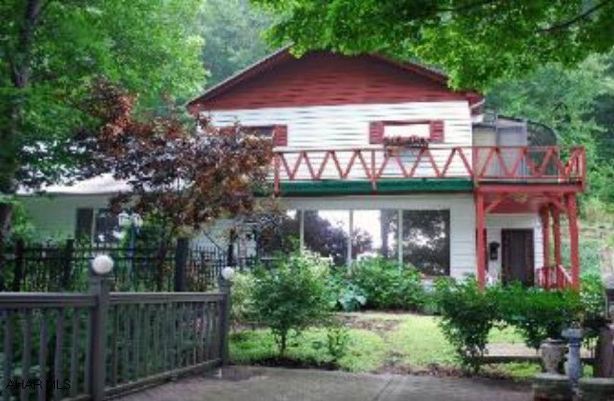 7 bdr, 2 3/4 baths former bed & breakfast on 7 private wooded acres.  Gateway to State Park & Rock Run, within in minutes to universities.  Property has a solarium, gazebo, & deck with scenic views.  Japanese & English gardens. Black top driveway.  Property is also suitable for a single family home.