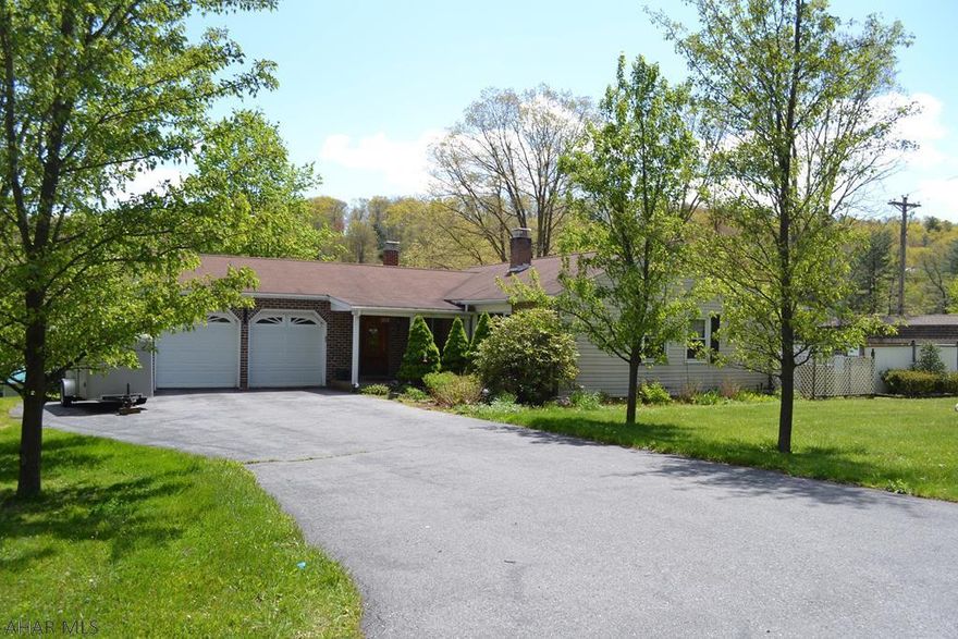 A must see inside! This well cared for 3 bedroom ranch home situated on over 1 acre is located in the Foor Addition just outside Everett PA.  Beamed ceiling living room with brick fireplace and lots of natural light.   Eat-in kitchen with stainless appliances and walkout to enclosed sun porch, doubles as laundry area.   Finished basement with ceramic tile floors, bar area, office area and additional bonus rooms.   Energy efficient heat pump, 2 car attached garage, large workshop/shed with electric, partially fenced yard.   Give us a call today!
