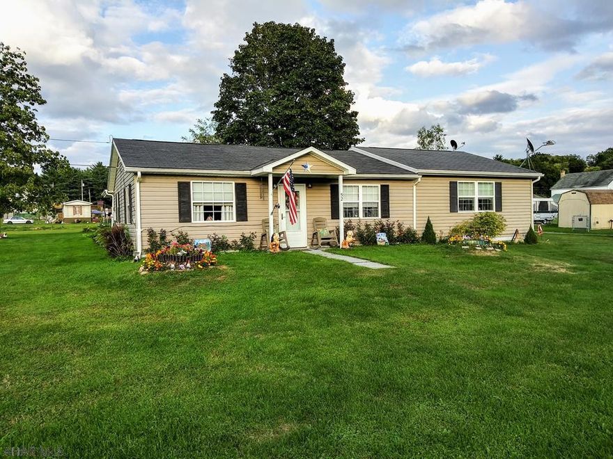 Lovely Ranch Home on 1.3 acres! Move right in to this Spacious home. Relax on the Covered Patio and enjoy your peaceful partially fenced yard. City Water & City Sewer. Very large 1.5 car Garage- Coal Furnace, Workshop, adjacent Shed, lots of storage. Garage has 200 amp.