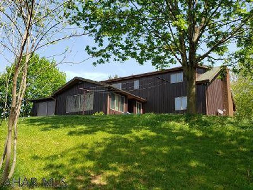 Beautiful 5-bedroom 2.5 bath cedar-sided home...larger than it looks! Great view from hot tub room, great room, back deck, 1st-floor bedroom & bath on 1.65 acres with attached 2-car garage, 2-bay detached garage, plus 2-story 1-car garage w/ loft. Immaculate home w/ hardwood floors, ceramic tile in kitchen, family room & baths + new carpeting. J-519