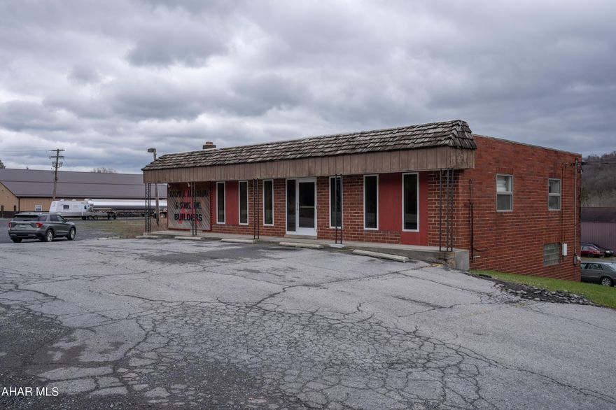 Four major improvements on this property include: A two story office building, two story metal storage warehouse, metal and concrete block garage/workshop and four one story residential rental units.  Ample space for parking around all buildings and residential units.  OFFICE consists of a foyer, reception desk, conference room, breakroom, two restrooms and several private offices as well as a large workroom with storage on the main floor.  Mini splits included to provide A/C.  The lower level features a receptionist station, restroom, garage area and mechanical room.  The two story rental units each contain living room, kitchen, two bedrooms and bath and are vacant.