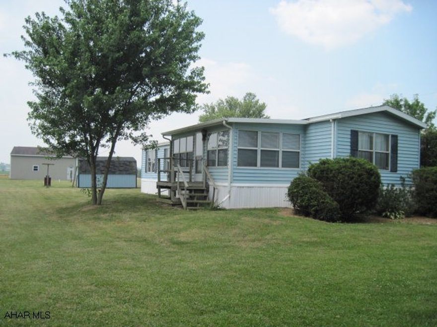 Gas available on Rt 164.  Beautiful flat 2.64 acre lot, 14x72 mobile home and roll out space in Dining Room.  Also a 10x20 sunroom addition.  30x40 Pole Building with electric and water.  12x6 Shed included.  Two water hook ups on property.  Two electric meters, city water, sand mound sewer.