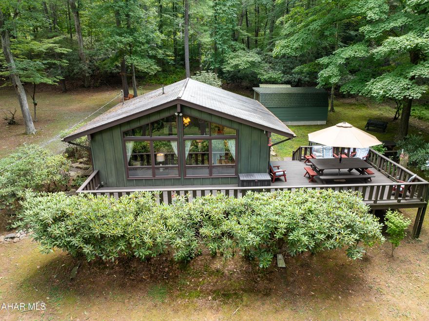 Welcome to the ultimate getaway, what a WONDERFUL setting ,nestled in the trees just a short walk to the River. Sweet cottage with living room/dining/ kitchen, 2 bedrooms and full bath. Full attic storage. Heat is an inviting propane stove in the living room, has a wall unit for cooling. 3 nice sheds outside for all your storage needs. Front deck has a view of the River , nice side deck and patio area for outside entertaining. Separate firepit area,  lovely landscaping , outside swing , everywhere you turn you will see  something that catches your eye. Cottage comes fully furnished, all outside furniture included, most of the shed contents will stay as well, even the lawn tractor. Come with some groceries and clothes, kick back and relax. Call to set up your tour!