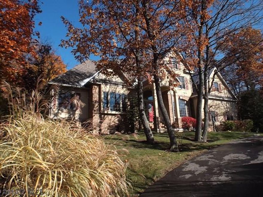 This quality built home has 4 bedrms, 4.5 baths on approx. 1+A . From the impressive 2 story entry, there's a formal dining rm with built-in buffet, cozy den, Great rm  with vaulted ceiling, fireplace and built in cherry bar. Spacious kitchen with cherry cabinetry, tile floor, breakfast bar & dinette area. Off the kitchen is a Florida rm. to a deck & backyard.  First floor Master suite with trey ceiling and spacious bath with  a Jacuzzi tub. Convenient laundry & powder rm. Second floor has a guest suite or 4th bedrm including a full bath & a back stairway. Two other bedrms. & a loft area..The lower level has a large finished family rm, exercise rm, full bath  Two furnaces and a/c units.  The 3 car garage & circular driveway with twin entrances complete this very special property.