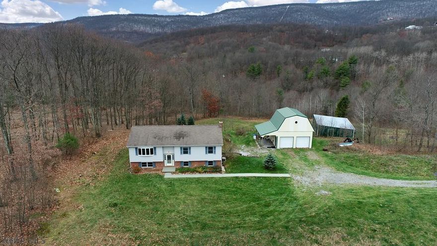 Country home on almost 5 acres.  The home is surrounded by woods and has a GORGEOUS VIEW from the decks.  It has animal stables, chicken coup, and a finished shop.  This is an outdoor lovers paradise!  It is a 25 minute commute to Altoona or State College.  Upstairs has a large kitchen with dining room and big loving area.  The home has 4 bedrooms including a master bedroom/bath on the main level.  It has a large family room in basement with bath.  There is lots of storage in the home.  You don't want to miss out on this great family home!