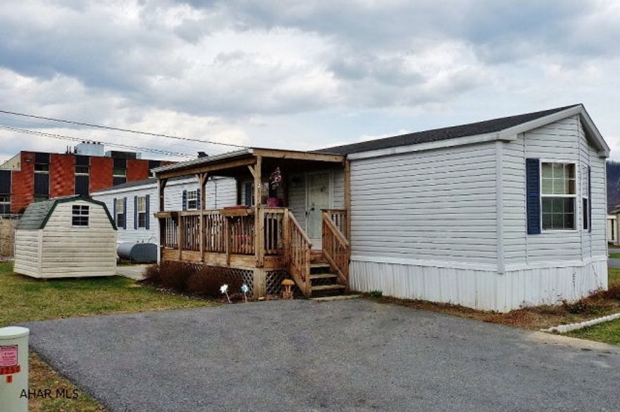 1999 Colony 14'x76' single-wide 2BD/ 2BA w/ oil forced air heat and central AC. Open floor plan; LR-DR-Kit (appliance incl). MBR suite at one end w/ French Door access to a large deluxe master bath w/ garden tub, with shower and double vanity. Separate laundry room. Covered deck/porch, paver patio and a 6'x8' shed on one side w/ 2-car paved parking.