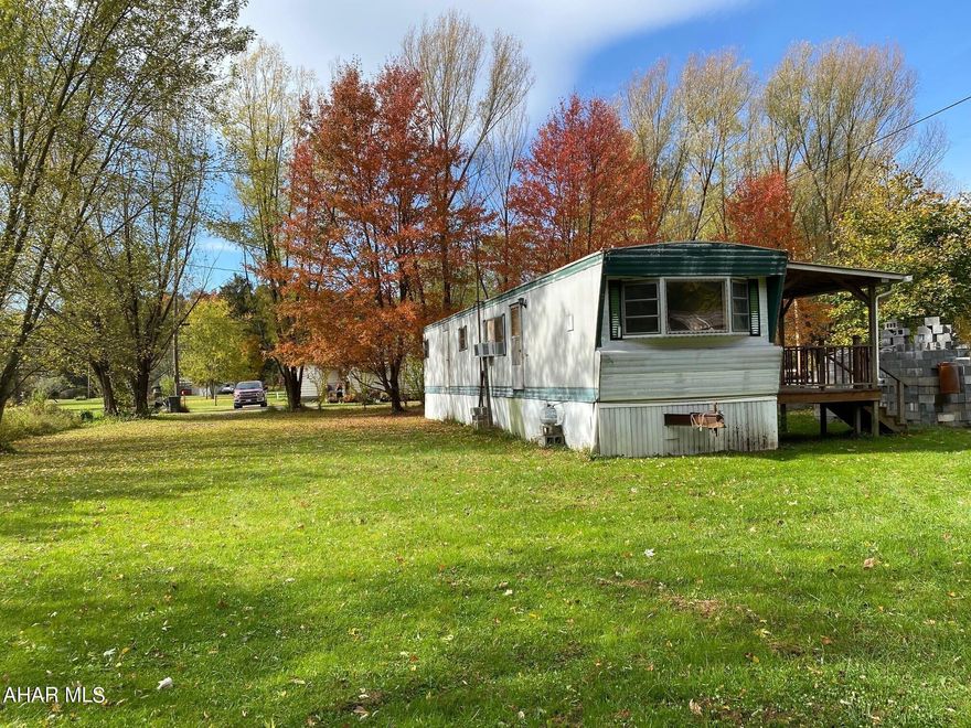 This could be a full time residence or a great vacation home.  Nice level lot.  Furnishings are included. This is a singlewide mobile home.  The item in the trailer stay.  Items in the garage do not stay.  Property is being sold as is.