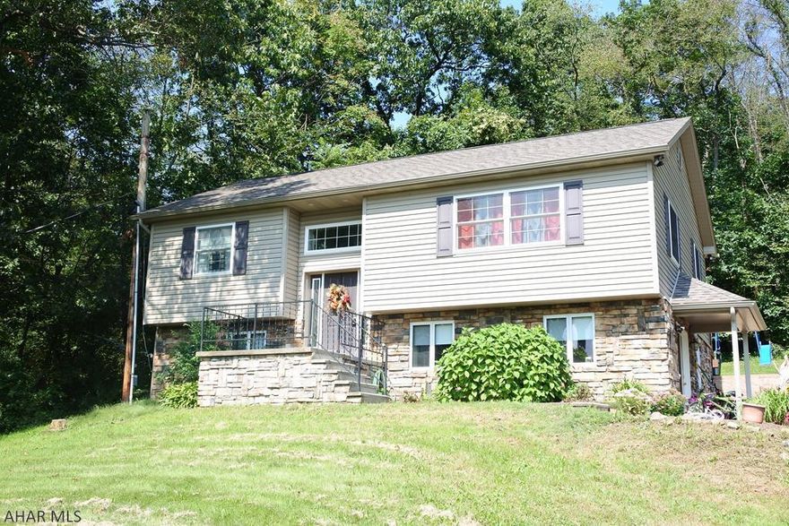 Perfect blend of Country and City living...close to everything, yet woods in your backyard. Lower level has a bedroom, plumbed for a full kitchen, bath and a bedroom or office.  New laminate flooring on the first floor, vaulted ceiling.  Nice sized master suite...double sinks and a large soaking tub!  Relax on the deck....enjoy a cozy campfire.... New , neutral carpeting is being installed in all bedrooms!!