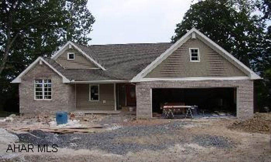 This vinly brick and stone sided home has lots of features.  gas fireplace, ceramic tile floors finished basement and two car garage