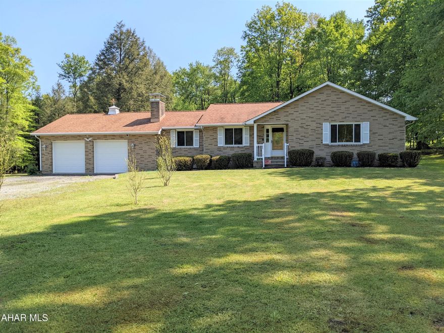 Ranch home on 16 acres in Jackson Twp - Central Cambria School District! This home is situated in Vinco on a picturesque setting among the trees and is adjacent to recreational activities. Rooms are large in size, and the living room, dining room and family room boast beautiful hardwood floors. Three bedrooms, ample closets, space, and two bathrooms round out the sleeping area. The kitchen is large with tile floors and a new cooktop and oven. From the kitchen, enter a great family room with a fireplace and a sliding glass door leading to the heated sunroom.  The basement is immense with so much potential and includes a combined shower and laundry room. The large front yard is lined with lamp posts that turn on with the flick of a switch! Enjoy the ambience of the outdoors and evenings, all while sitting around the campfire!  When you tour this one-owner home, you can't help but feel the ''I could definitely live here'' vibe!