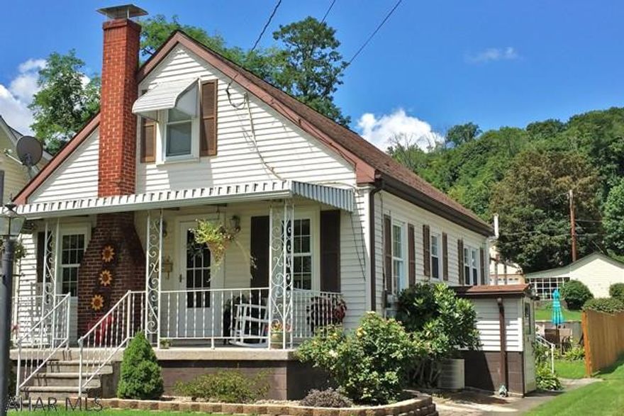 Charming 1 1/2 story 2 BR-1BA cottage home with hardwood floors and beautiful woodwork.  Great outside living spaces with large covered front porch, patio, pool, and lovely landscaping.  Property offers a detached garage with a canopy carport and an off-street parking pad.  The 12x20 garage has power and could make a nice workshop.  This home is located in a well maintained neighborhood and very convenient to town.