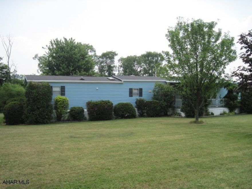 Owner looking for offers! Beautiful flat lot.  2.64 acres with a 14x72 mobile home and rollout for extra space in Dining Room.  Also a 10x20 Sun Room addition.  30x40 Pole Building with electric & water.  12x6 Shed included.  Two water types on property.  Two electric meters.  City water, sand mound sewer.