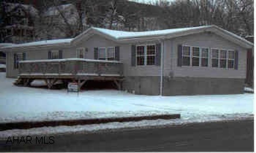 Lovely double wide on 1/2 acre lot with 2 car stone garage.