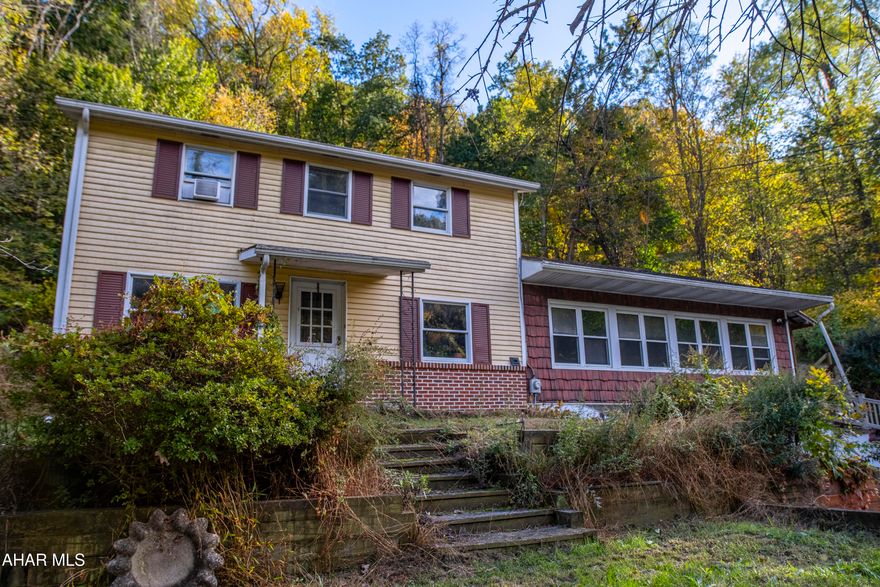 Discover your peaceful retreat just moments from everything in Lewistown. Tucked away on a quiet street at the end of Woodbine Road, this spacious two-story home offers the perfect blend of convenience and privacy.

With over 2,400 square feet on a generous half-acre wooded lot, you'll feel a world away while being close to every amenity. The heart of the home is the huge family room, an ideal gathering space featuring beautiful wide-plank flooring, a cozy pellet stove, and an efficient mini-split for year-round comfort.

Step outside to enjoy the serene, partially wooded surroundings from your covered patio or the separate detached deck—perfect for summer relaxation and entertaining.

The main level is designed for easy living and includes a bright kitchen, a dedicated dining room, a traditional living room, a full bathroom, and a convenient laundry room with a pantry. Upstairs, you'll find three comfortable bedrooms and a second full bathroom.

Complete with an integral two-car garage and a private driveway, this property is ready to be your next home!