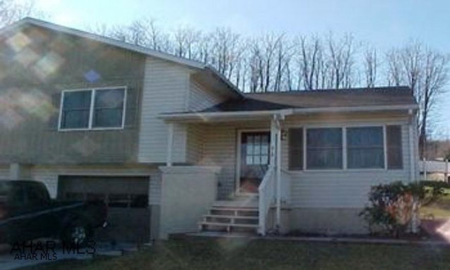 Half double, remodeled, nicely decorated, electric baseboard and storage heat.  Garage and laundry on ground level.