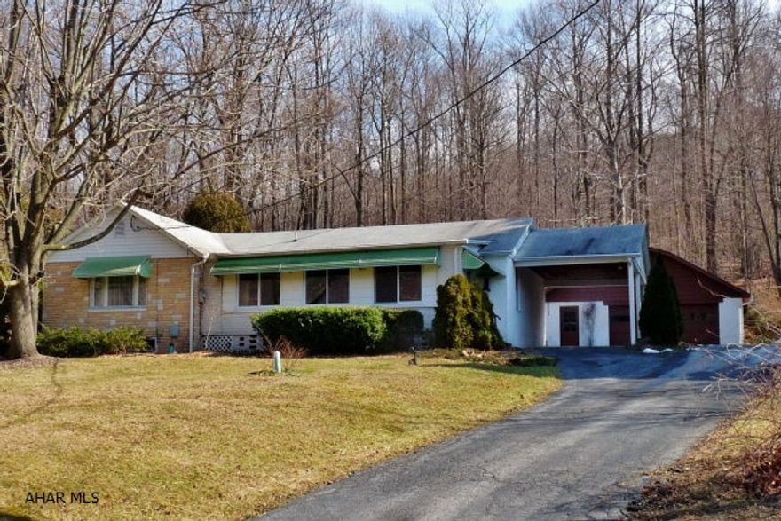 A 3BR/1BA ranch home w/ main floor laundry, OHW heat, 3-season sun-porch, large stone patio, carport, enclosed front porch once used for business and a 30x30 detached 2-car garage/shop w/ overhead storage. Lg 1.5 acre hillside lot w/ woodlands to the rear and mountain views to the front.