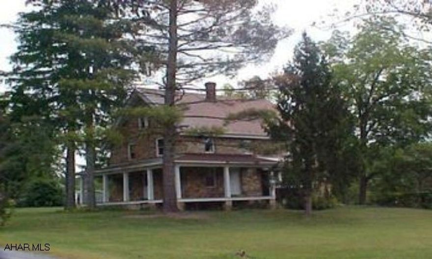 Many Possibilities!  Stone home (currently a triplex) with wrap-around covered porch, detached 2-car garage, & 3 parcels (total of .872 Ac.).  Along Lower Brush Mtn. Rd. near Pond & Godfrey.  (2 Lots are 100 X 130; 1 lot is 100 X 120).  #J-026