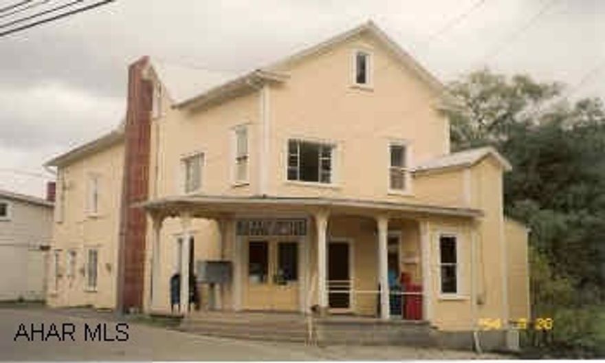 Great investment property. Bottom unit rented by U.S. Post Office. Top  unit has 2BR apartment. Large open area for storage in remainder of building. Roof is metal and rolled roof.