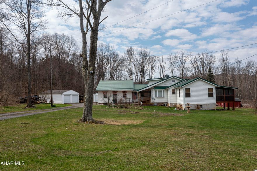 Discover a rare gem with this charming ranch-style home set on nearly 5 serene acres. This well-maintained property offers a 3-bedroom, 2-bath layout with an impressive amount of garage space including an attached 3-car garage, a detached 2-car garage, plus an additional 1-car garage/shed. A peaceful stream runs along the back of the property, adding a touch of natural beauty and tranquility.

Inside, you'll find a spacious eat-in kitchen with stainless steel appliances, a formal dining room, and a cozy living room—perfect for both everyday living and entertaining. The home is equipped with a high-efficiency geothermal heating and cooling system, providing year-round comfort while keeping energy costs low.

Step out back to a screened-in porch where you can relax and take in the privacy and quiet of your surroundings. Recent updates include new windows (2015) and a roof replacement (2011), giving peace of mind for years to come. This is country living at its best with space, comfort, and thoughtful updates throughout.