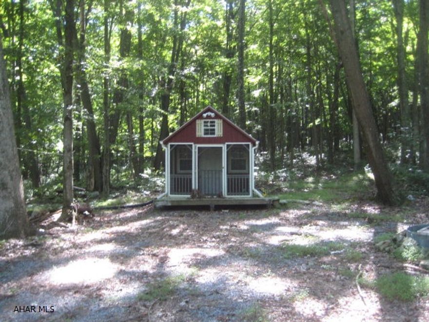 Private weekend getaway/Hunting camp in Bedford county. Stucture is 10x16 nicely done inside with log cabin appearance includes a 4x10 screened in porch and 4x10 porch.  Located in a great hunting area, with other Public State Game lands within minutes. The camp is powered by a new generator that will remain if the price is right. Heated by propane (wall unit).This is a 10 acre site that could make some a awesome home site or larger camp site. There is plenty of room to develop or park additional RV campers. It would also make someone a great little private hunting spot. Electricty could be easily added to the property. Located 15 minutes from Bedford.