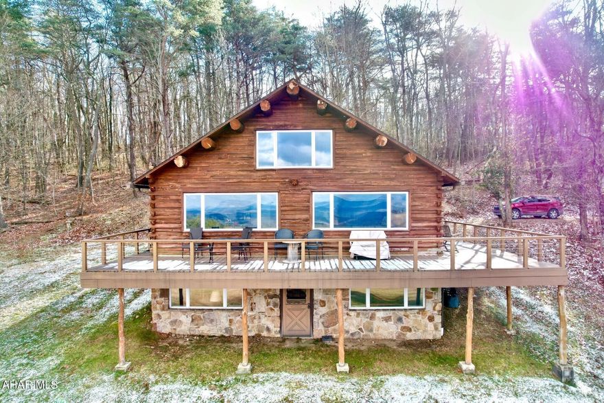 Simply stunning views are what you notice first at this lovely cabin situated on 13 acres.  Rustically charming, this home features beautiful wide-plank hardwood floors, open living space and gorgeous full exposed beams in the cathedral ceilings.  The finished basement and spacious wrap-around porch overlook some of the most breathtaking views in the county.  

The loft upstairs overlooks the living space below and also takes advantage of the vast views of the countryside.  As a part of the membership of Glade Spring, property owners enjoy a myriad of amenities including a private lake perfect for kayaking and fishing, numerous hiking trails and a community farmhouse which can be used for events and/or guest housing.  If you are ready and looking for a little piece of tranquility this side of Heaven, check out this beautiful home.