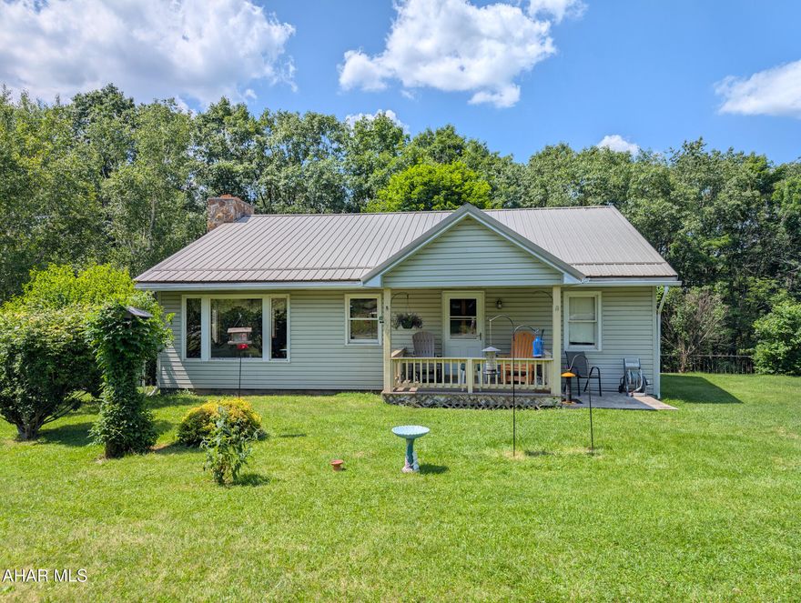10 acres in the Allegheny mountains.  Mountain life at its best.   Great room with stone wood fireplace, wood ceiling, windows that bring nature in doors,  and sliding glass door to the back deck overlooking the woods and wildlife.  Sit on the front porch or the back deck and listen to the sounds of nature.  3 bedrooms on the main level with a bonus room, canning kitchen, laundry and full bath in basement.  2 car detached garage with additional storage in the back.  Hunters paradise or nature lovers canvas.  Close to Rt 56, I99, and Pa turnpike.