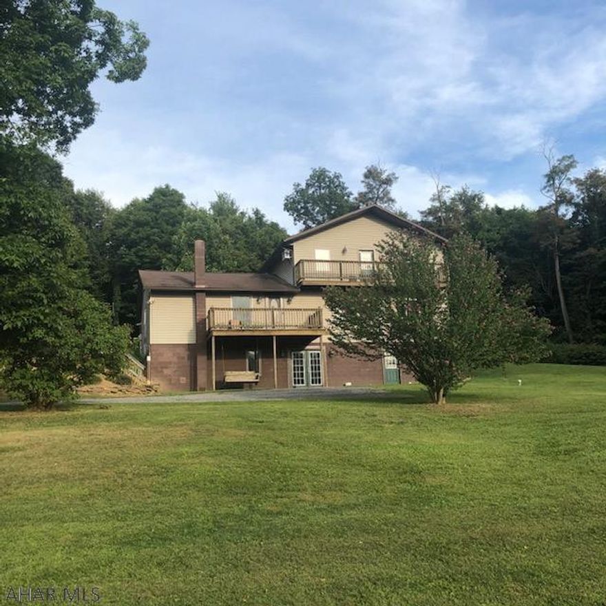 Looking for a get-a-way nestled in the hills with views of the surrounding mountains that literally makes you want to kick back, put up your feet and relax for a bit? This spacious home has three levels of living space starting with the basement and its large family area, laundry, bedroom, 3/4 bath and bonus room for a possible 5th bedroom, exercise room or storage area. The next level you'll enjoy two bedrooms, full bath and a huge open area for gathering in the kitchen/dining/living room with easy access to the outdoor area. Walk up to the 2nd level of this home and in to your very own private Master Suite complete with master bath and wet bar. Walk out on one of the two decks and enjoy the tranquility of this property. Located close to State Game Lands!  Horses are welcome!