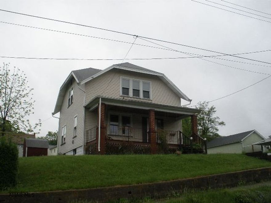 2-story home with vinyl siding. Rear off-street parking.