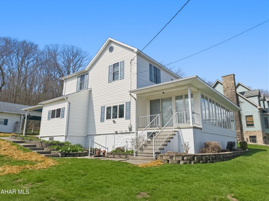 Welcome to 1040 Station Road in Twin Rocks - an impeccably maintained home situated on a spacious corner lot that truly stands out for its pride of ownership and exceptional condition. The main level offers a bright and inviting sunporch with floor-to-ceiling windows, perfect for relaxing or entertaining. Inside, you'll find a formal dining room, comfortable family room, and a spacious eat-in kitchen with plenty of room for gatherings. Additional conveniences include first-floor laundry, a full bathroom, a main-level bedroom, and a functional mudroom. Upstairs, the home features four generously sized bedrooms along with a second full bathroom. The basement is unfinished but exceptionally clean and well-kept, providing excellent storage space or potential for future use. Outside, enjoy the large corner lot with a private feel, a covered rear patio, a detached one-car garage with an attached carport, established grapevines, and plenty of yard space to enjoy. This home is a rare find in such outstanding condition. Schedule your showing today!