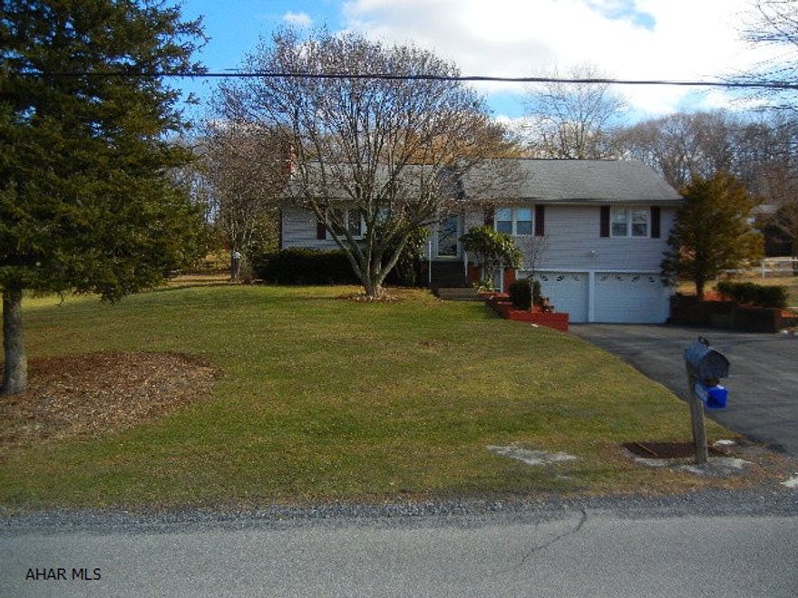 Great area in Sunbrook off 764, convenient to I99.  Family room with dry bar, large laundry room includes front loading washer and dryer.  Hardwood floor in dining area.  Stone fireplace in LR.  Sunroom in rear.  Deep lot with 2 sheds.  Flagstone patio.  Two car garage with automatic openers.  Nice view of the mountains.  Well maintained and move-in ready.  One year home warranty.