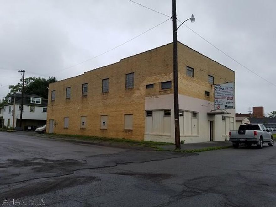 This is the MI Supply Building. First floor is retail and garage with 2nd floor storage. There is a paved lot next to the building. Additional grass lot included.
