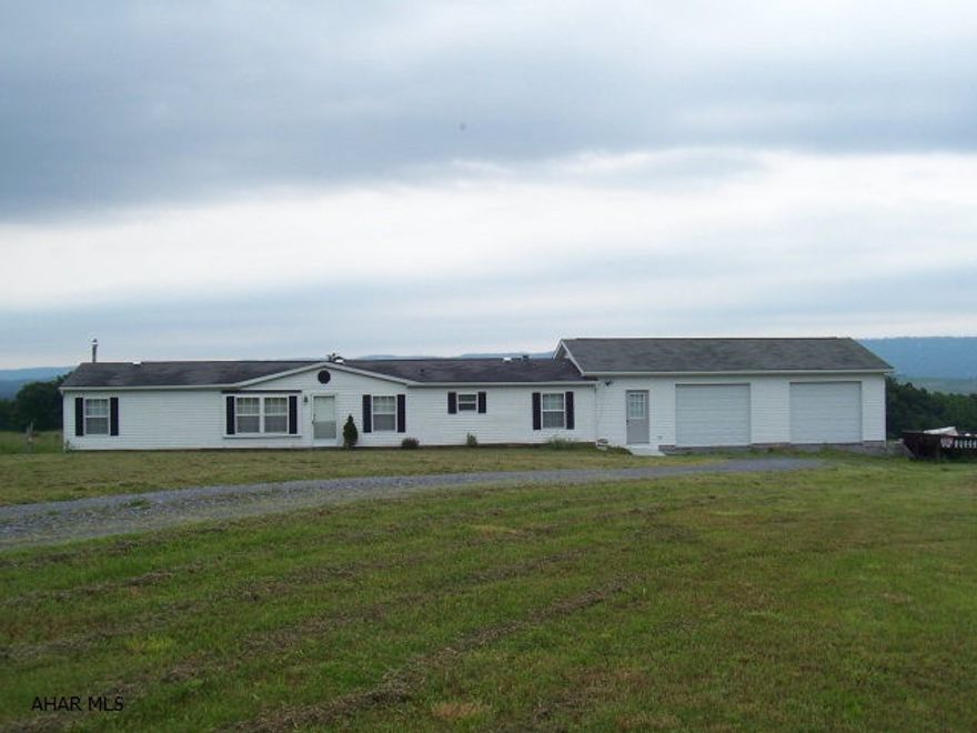 A well maintained 1998 68x28 Redmen doublewide on 5.36 acres with a 34x25 attached 2 car garage. 3 bedrooms and 2 full baths, open eat-in oak kitchen  with island. Kitchen like new!! Catherdal ceiling/skylights and spacious rooms. Master bedroom/bath with a large garden tub, seperate shower and double sinks. Beautiful views of the mountains, private and peaceful. Additional 30+/- acres can be purchased at $89,900.