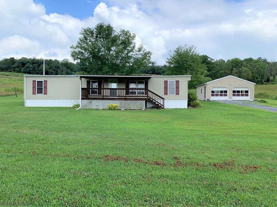 Well maintained double-wide home resting on 1.534 acres!! It offers a living room, dining room, kitchen with breakfast bar & dining area, three bedrooms and one bath. Many updates throughout including oak kitchen cabinets, floor coverings, interior paint, replacement windows, vinyl siding and a metal roof. Front covered porch, rear enclosed porch, detached two-car garage and a storage shed. Oil forced air heat, private well that is shallow according to the power-of-attorney, and a private septic system. Kick your feet up on the front porch, relax and enjoy the great country views!!