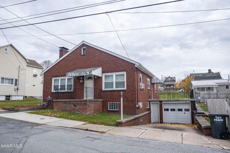 This single-story brick home sits on a large lot and features two bedrooms and two bathrooms. The interior layout includes a kitchen, a dining area, and a living room with a fireplace. The property boasts newer windows, an integral garage, and a welcoming large porch out front. For storage, there is a walk-up attic, and the home is complete with a large, unfinished basement suitable for future finishing. This is a must see.