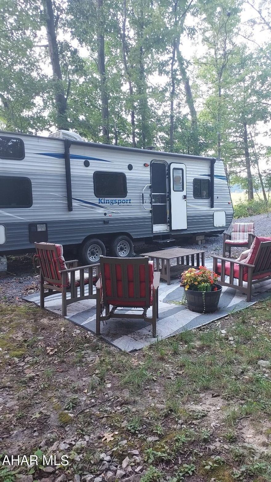 Here is your chance to own that get-a-way just minutes from the lake that you've been dreaming of! Not only is it a serene piece of partially wooded land but it comes complete with a 2019 Gulfstream Kingsport camper, electric connected, fully furnished and ready for you to enjoy. Includes everything you see outside as well; outdoor furniture, picnic table, firepit and grill. Don't miss this opportunity to escape from it all, at least for a long weekend!