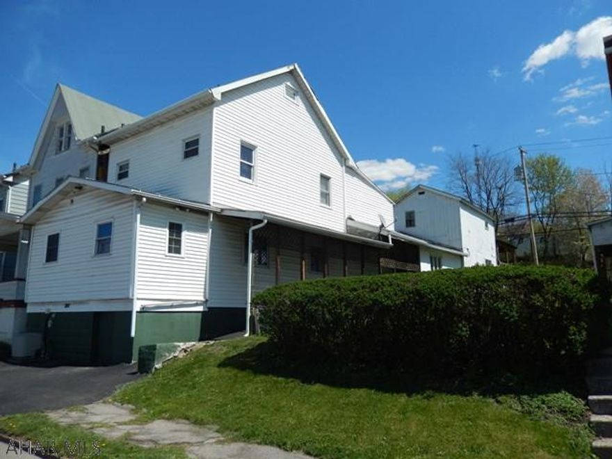 Great property for a large family or INVESTOR. Large main house ... 3 to 4 bedrooms. 2 baths. Wheel chair accessible. Good mechanics .. Newer furnace, Central Air, hot water heater, electric.   There is a small house attached to the back of the main house,with a separate entrance, includes bath ,kitchen etc ... which needs a lot of TLC.   A walkway goes from both dwellings to the 2 car carport (18 X 21) in the rear. There is no grass! This property is sold "AS IS".