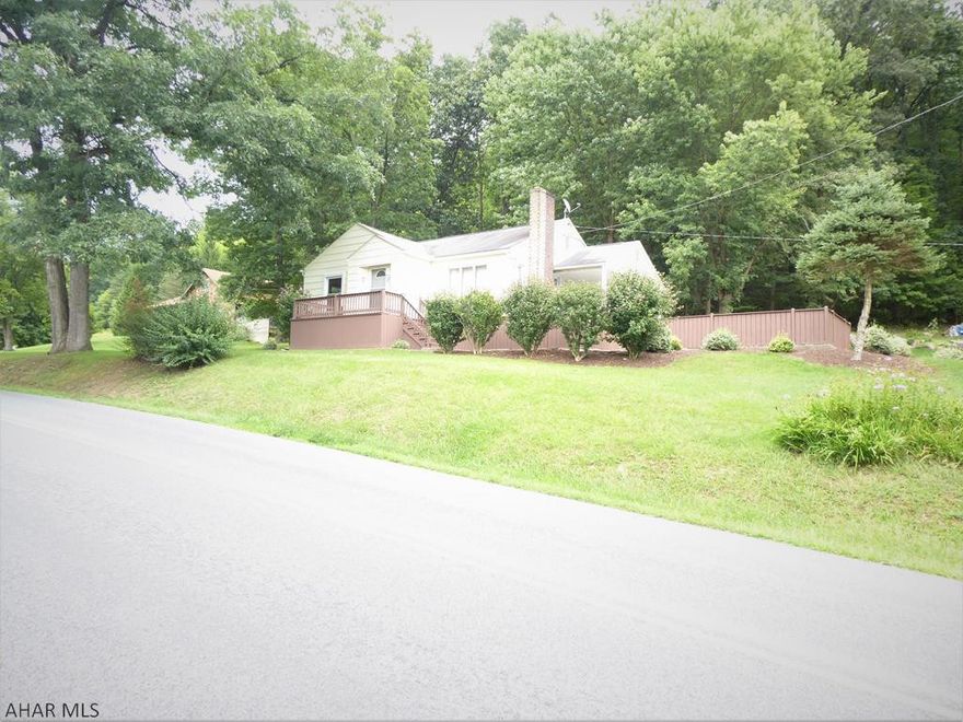 A charming 2 bedroom home on over an acre,.  Sit back and relax on the cement patio off the kitchen and enjoy the view of the wooded back yard and stone landscaping with its mature flowers, or enjoy sitting on front porch or the side porch.  This well maintained home has many features that set it apart from other homes.  The recently remodeled basement has a great space for a movie theater room, family room, or additional living room.  The basement has an additional bonus room that could be an office or den.  Only 2 miles from downtown Bedford.  Easy commute to Pa  turnpike, Hwy 70, or I99.