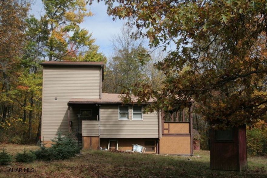 This cozy chalet is located in the gated community of Buck Run in New Paris. Enjoy privacy and a relaxing getaway in this 3 BR home. The deck on the back of the home is perfect for sipping your morning coffee. Wildlife abounds in the quiet woods surrounding the property. A spiral staircase in the home adds to its charm and uniqueness. The living room has a high vaulted ceiling which creates an open and inviting space. Call today to see this home and it could be yours to enjoy!