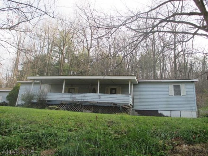 Spruce Creek area mobile home on 1 acre with partial foundation and large 2 car garage. Needs major TLC. Sold AS-IS.